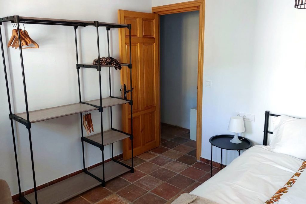 Bed and clothes rail in Rigoletto